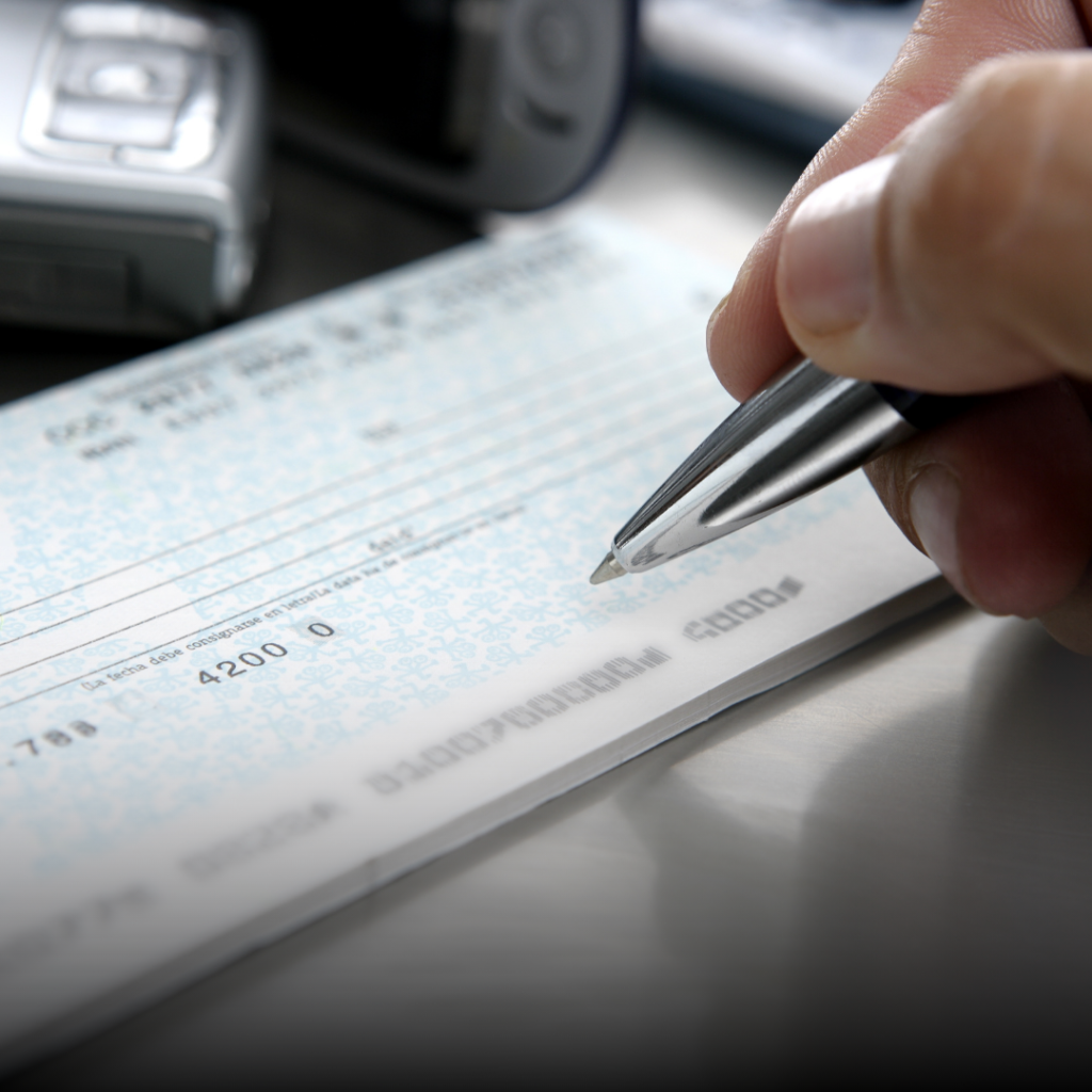 Hand writing a cheque with a pen