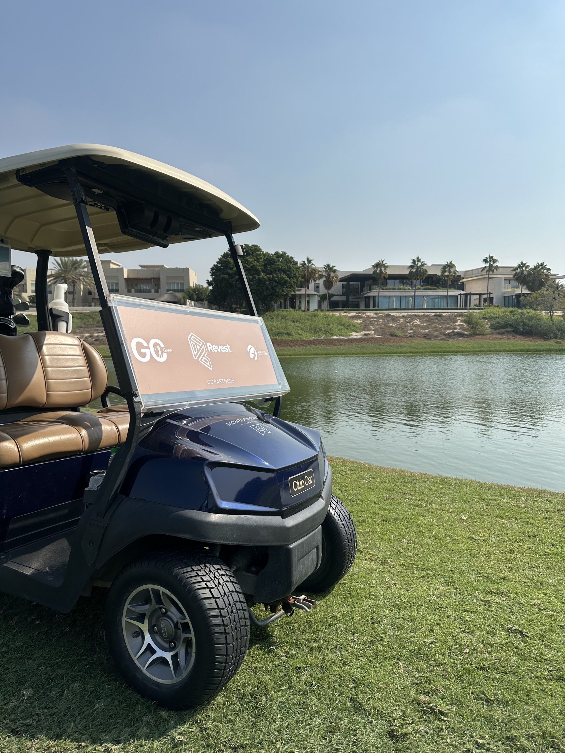 Golf buggy parked beside a fairway on a Dubai course